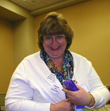 Deb Geisler, Chair of Noreascon IV, Shows off Her Buttons